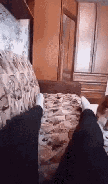 a person is sitting on a couch with their feet up