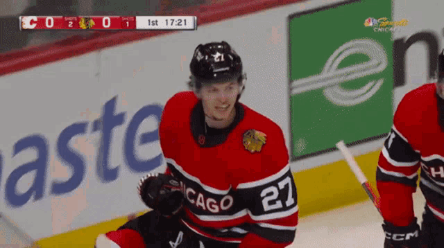 a hockey player wearing a jersey that says chicago 27
