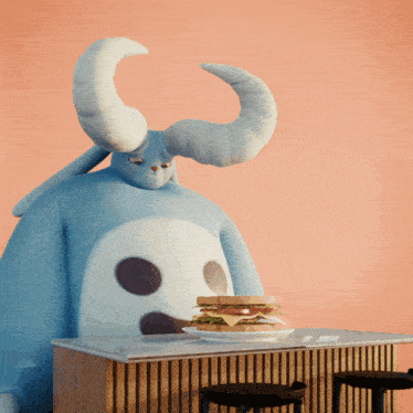 a cartoon character with horns is sitting at a table with a sandwich on it