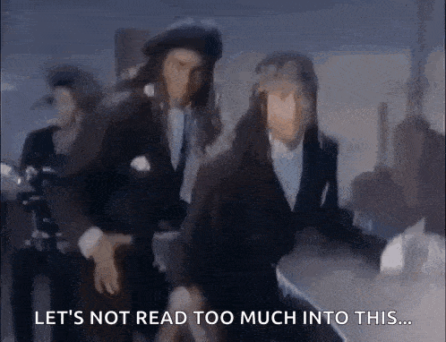 a group of people are dancing in a dark room .
