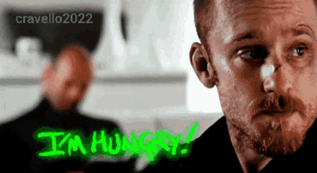 a man with a green i 'm hungry sign on his face