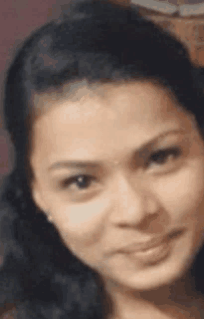 a close up of a woman 's face with a smile on it