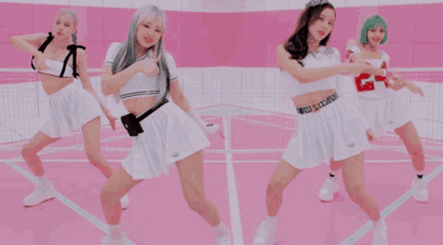 a group of women are dancing on a pink court .