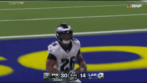 a philadelphia eagles football player runs on the field