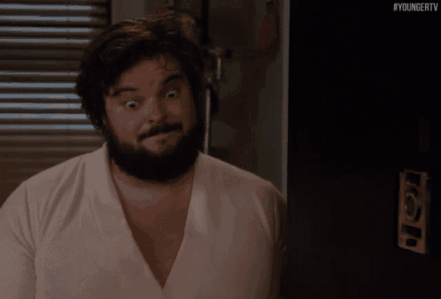 a man with a beard is wearing a pink shirt with the hashtag #youngertv on the bottom right