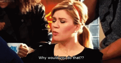 a woman is sitting at a table with a cup of coffee and asking why would you do that ?