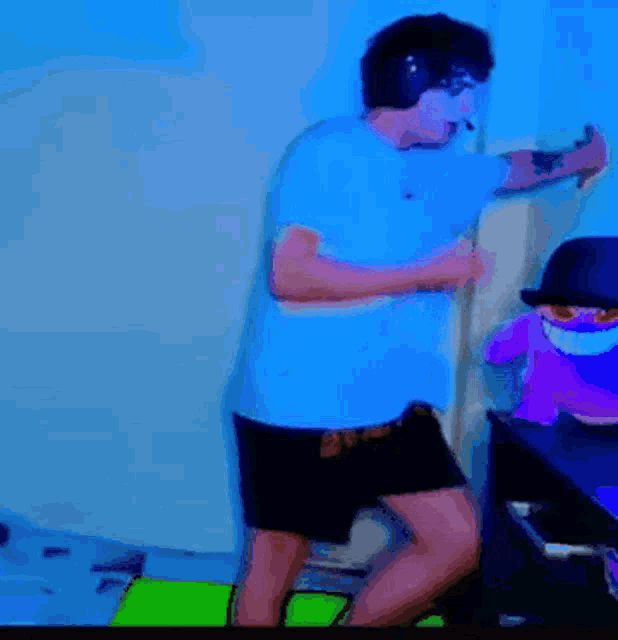 a man in a blue shirt and black shorts is dancing