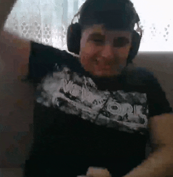 a man wearing headphones and a new york shirt is dancing .