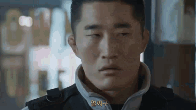 a close up of a man 's face with a foreign language written next to him .