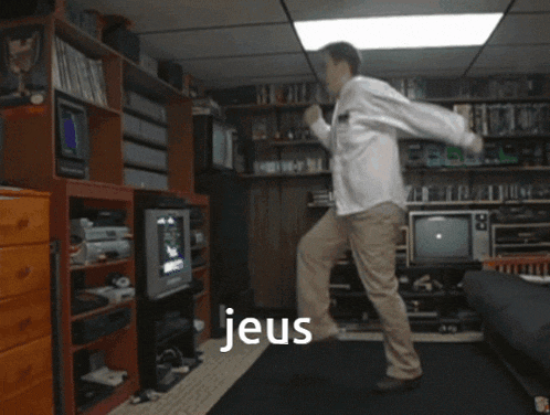 a man is kneeling down in a room with the word jeus on the bottom right