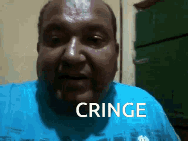 a man in a blue shirt with the word cringe written on his face