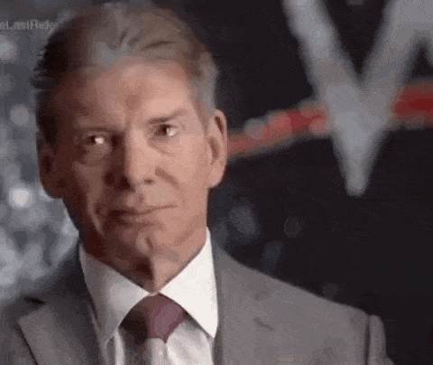 a man in a suit and tie is making a serious face .