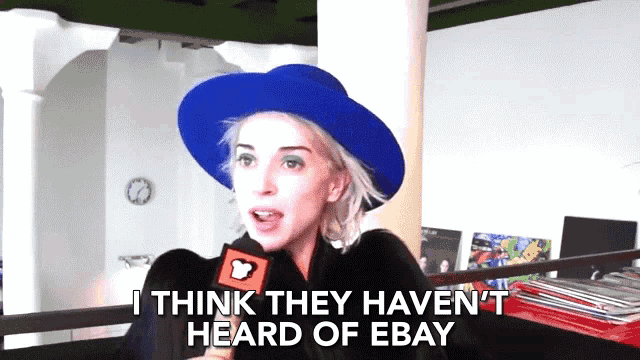 a woman in a blue hat is talking into a microphone and says " i think they haven t heard of ebay "