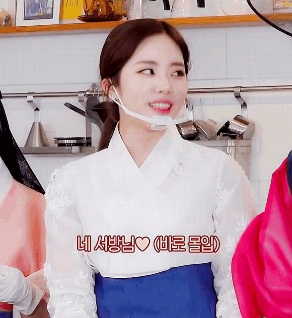 a woman wearing a white shirt and a blue skirt has korean writing on the bottom of her shirt