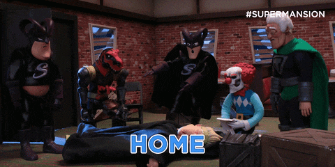 a group of superheros are standing around a man laying on the floor with the words he he he above him