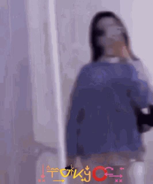 a blurry picture of a woman with the word tokyo on the bottom right