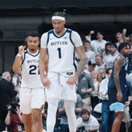 two butler basketball players are standing on the court