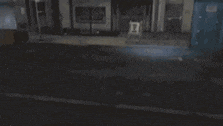 a man is kneeling down on the ground in a video game while holding a knife .