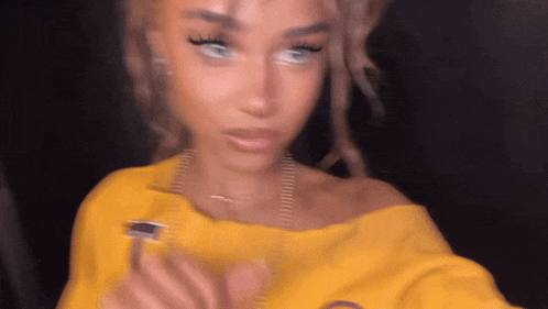 a blurry picture of a woman in a yellow sweater
