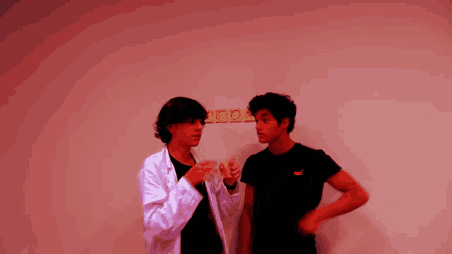 a man wearing a puma shirt stands next to another man