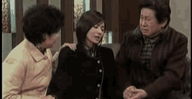 a man and a woman are sitting next to each other in a room .