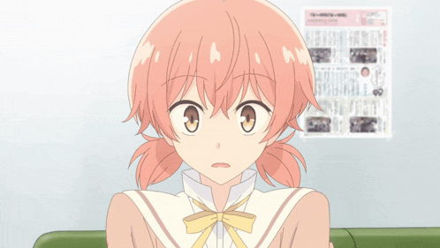 a girl with pink hair is sitting in front of a wall with a newspaper hanging on it