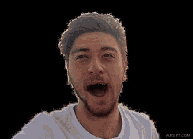 a man in a white shirt is making a surprised face with his mouth open
