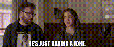 a man and a woman are standing next to each other and the man is saying he 's just having a joke