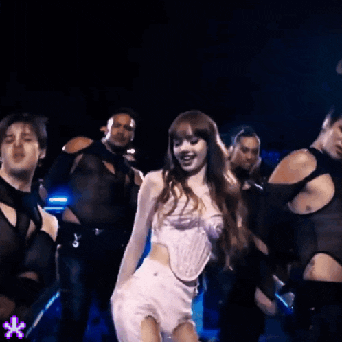 a woman in a white top and shorts is dancing in a dark room