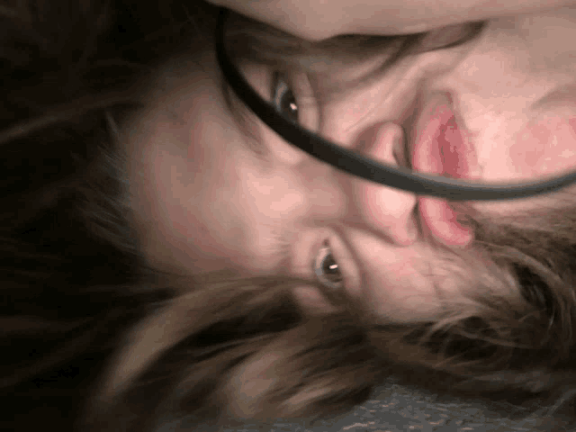 a close up of a person 's face with a black headband on