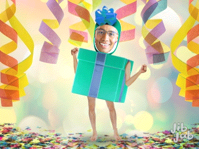 a man is dressed as a gift box with a bow on top