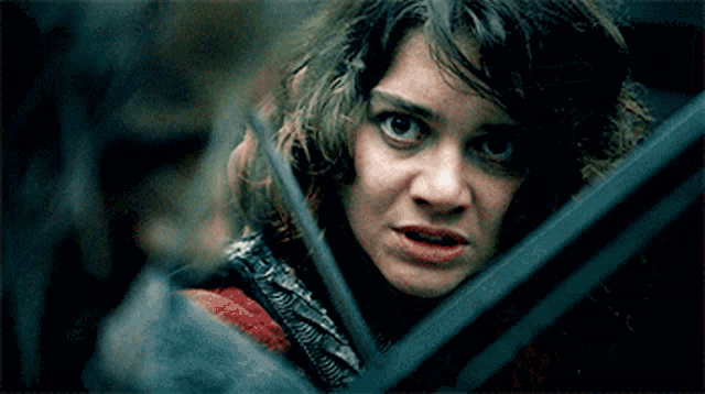 a close up of a woman 's face with a serious look on her face .