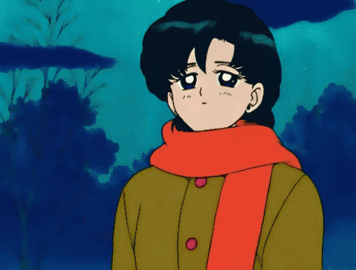 a girl wearing an orange scarf and a yellow coat