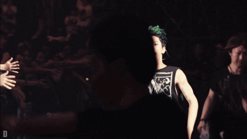 a man with green hair is wearing a tank top that says ' guns n ' roses '
