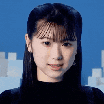 a close up of a young woman 's face against a blue background .