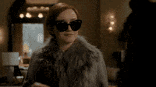 a woman in a fur coat is talking on a cell phone