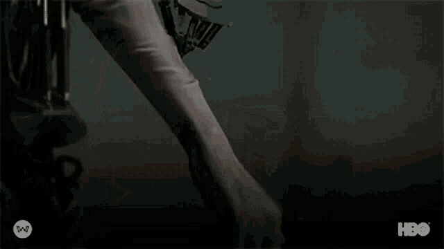 a close up of a woman 's arm with a scar on it in a dark room .