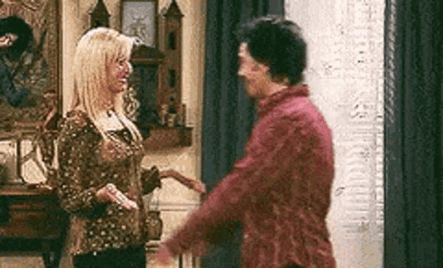 a man and a woman are standing next to each other and hugging .