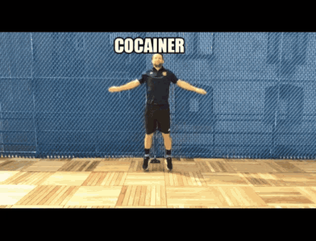 a man in a black shirt is doing a jumping exercise with the word cocainer above him