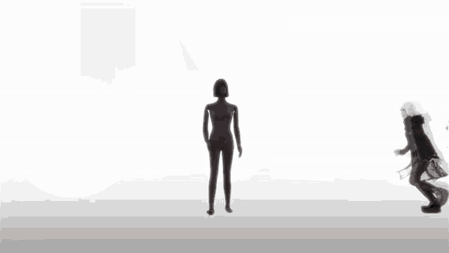 a couple of people standing in front of a black circle with white stripes