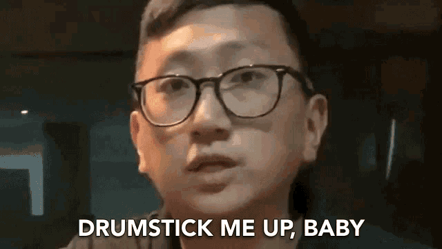 a man wearing glasses is saying `` drumstick me up baby '' .