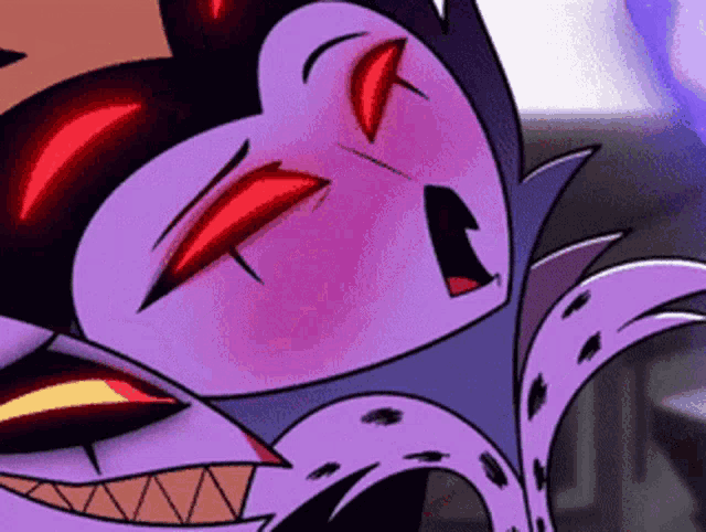 a close up of a cartoon character 's face with red eyes and teeth .