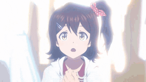a little girl with brown hair and a pink bow in her hair is looking up at something .
