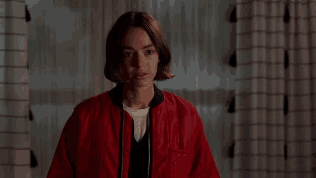 a woman in a red jacket is talking about being her girlfriend