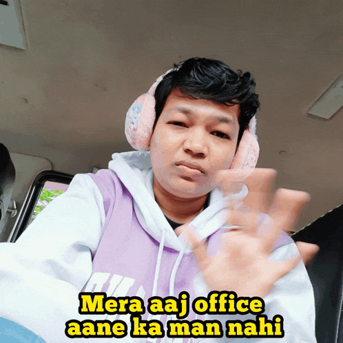 a man wearing ear muffs and a purple hoodie with the words mera aaj office aane ka man nahi