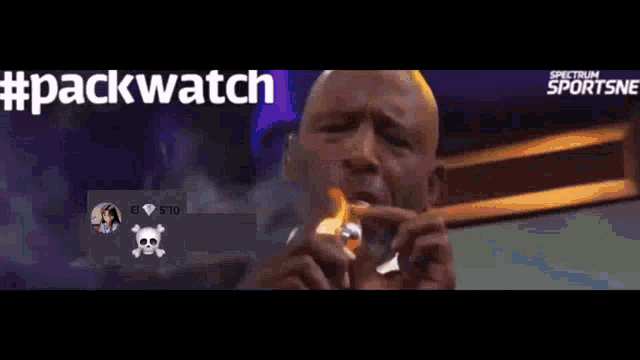 a man is lighting a cigarette in front of a spectrum sportsne ad