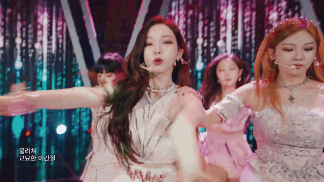 a group of girls are dancing on a stage .