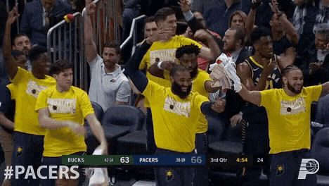 a group of basketball players wearing yellow shirts with the word pacers on them