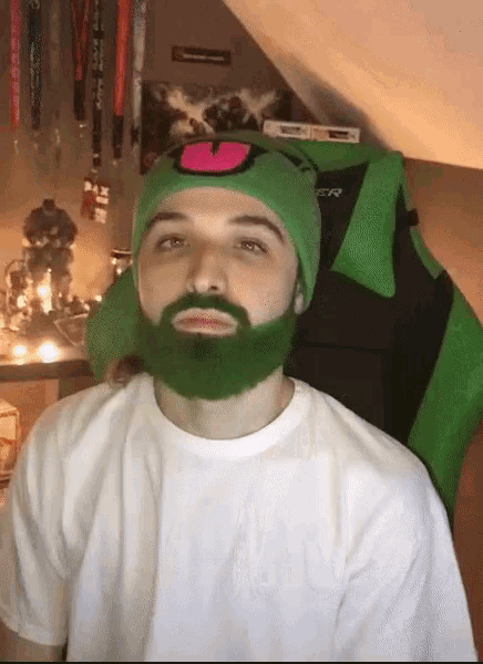 a man with a green beard wears a green hat