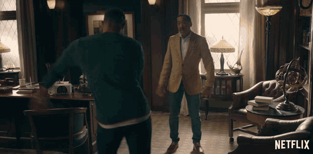 two men standing in a room with a netflix logo